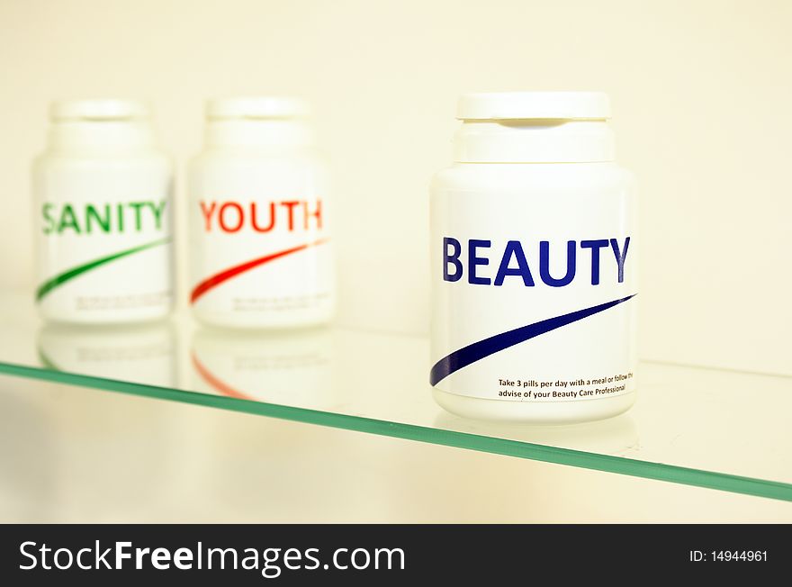Sanity, Beauty and Youth pills in a bottle on bathroom shelf with focus on Beauty, fake brands
