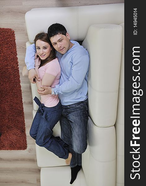 Couple relax at home on sofa in living room