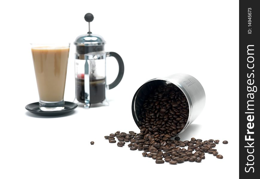 Coffee beans in a canister and a coffee plunger isolated against a white background