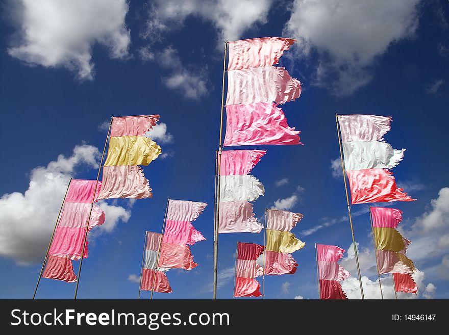 Vibrant display of flags against deep blue cloudy sky. Vibrant display of flags against deep blue cloudy sky