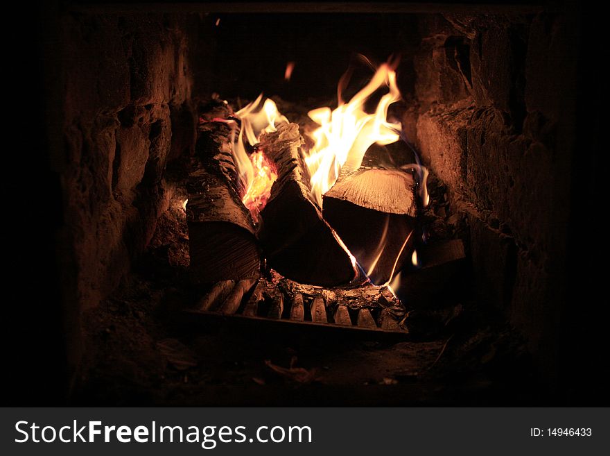Burning Firewood In A Fireplace.