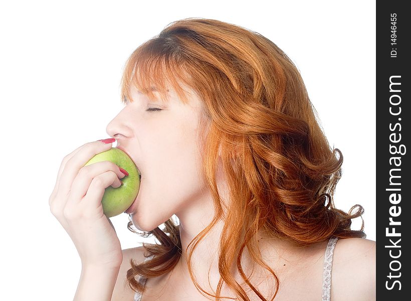 A beautiful young woman biting a fresh green apple. A beautiful young woman biting a fresh green apple.