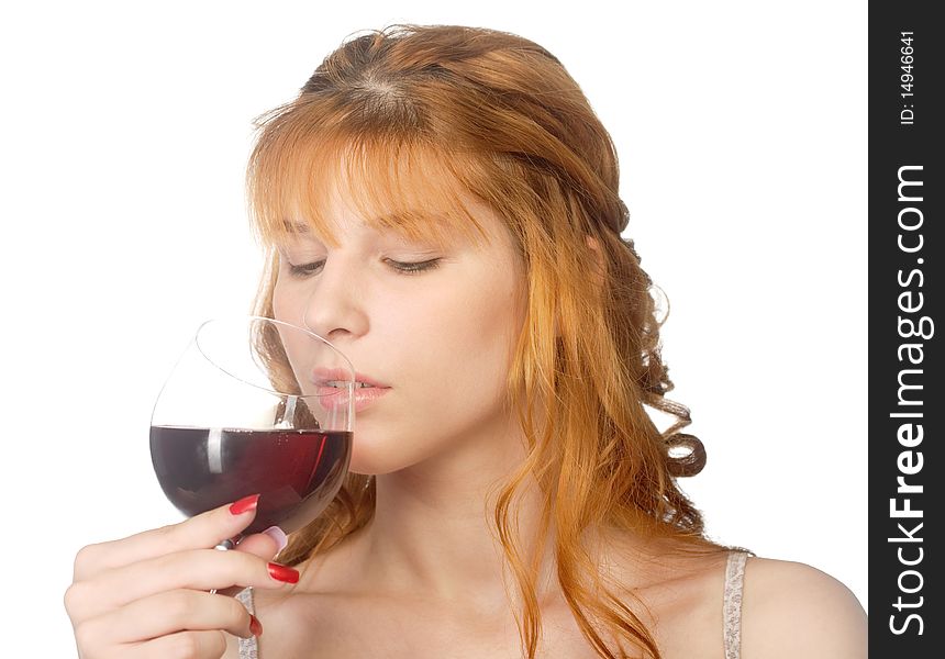 Attractive redheaded young woman drinking red wine. Focus is on the girl, not the drink.