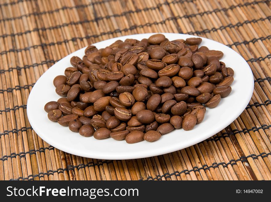 Macro of coffee beans on plate