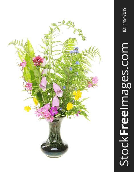 Arrangement of wild flowers and ferns in a vase