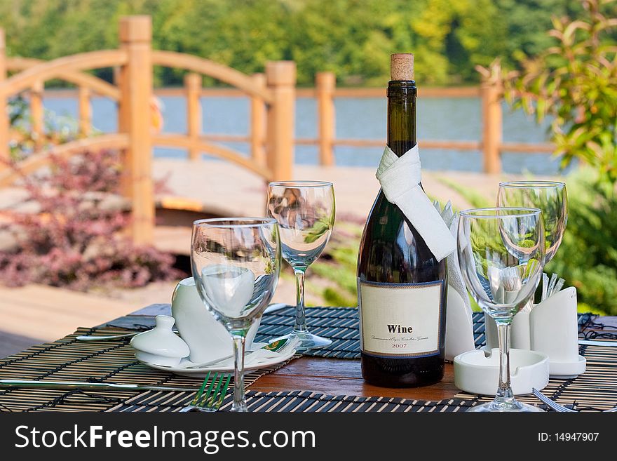 Beautiful served table in front of picturesque lake