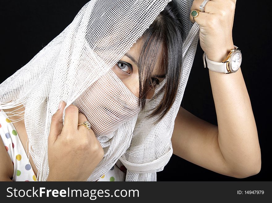 Arabian girl covering her face with white stole.