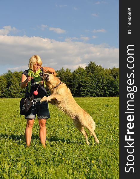 Happy young woman playing with her golden retriever. Happy young woman playing with her golden retriever