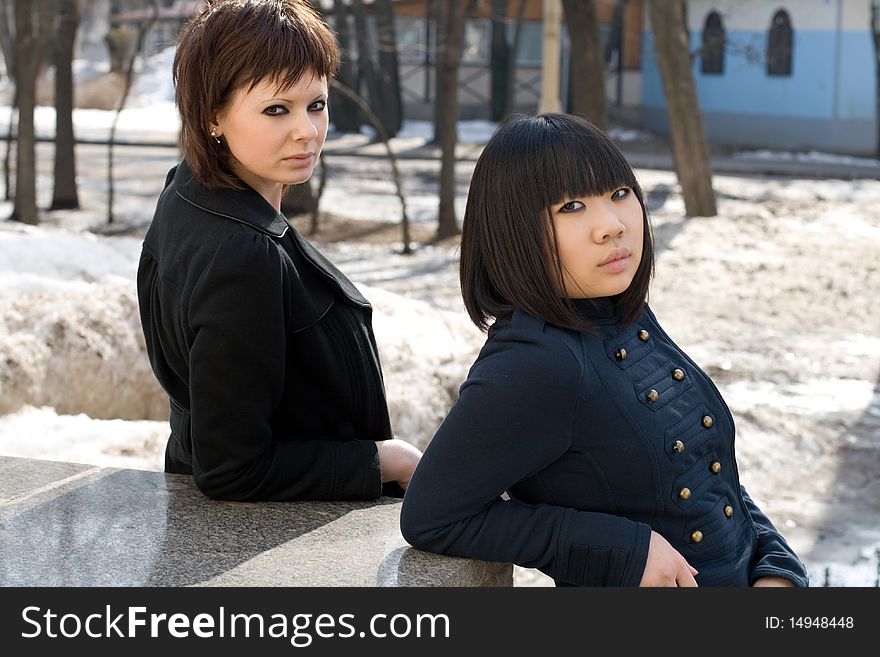 Two female friends walking outdoor