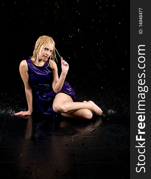 Full length portrait of a woman in water studio