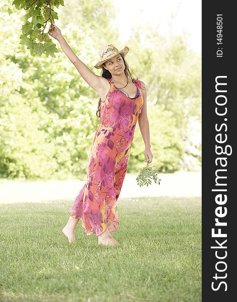 Young attractive woman walking towards camera in a field