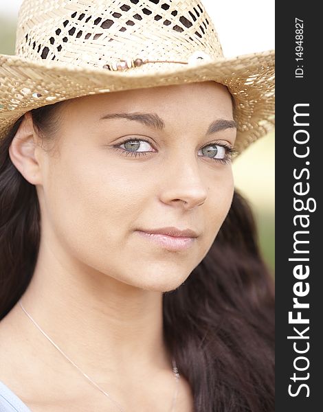 Portrait of  attractive young woman wearing straw hat. Portrait of  attractive young woman wearing straw hat