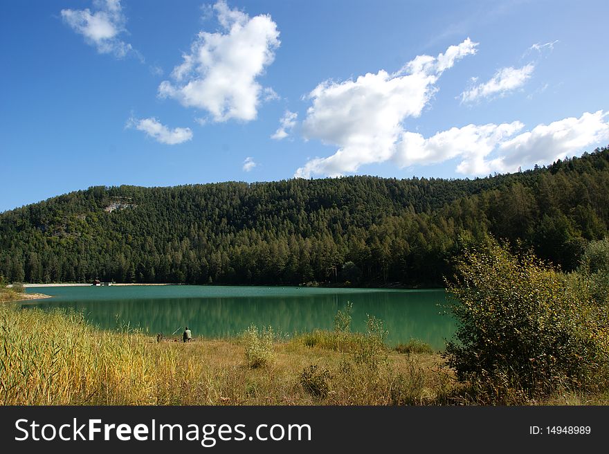 A view of the Alpine-South Tyrol with the background of emerald green lake. A view of the Alpine-South Tyrol with the background of emerald green lake.