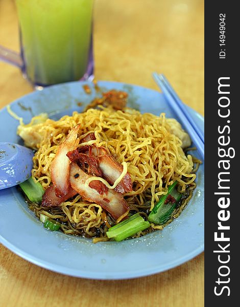 Closeup of wantan noodle (chinese noodles) with roasted pork meat.