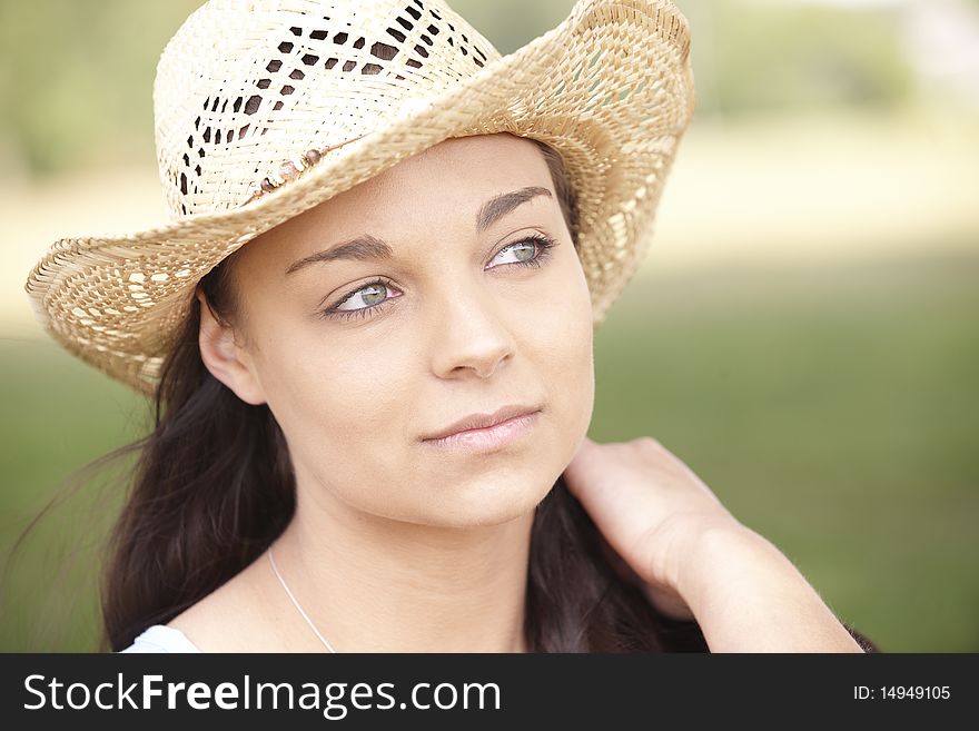 Portrait of thoughtful attractive young woman wearing straw hat. Portrait of thoughtful attractive young woman wearing straw hat