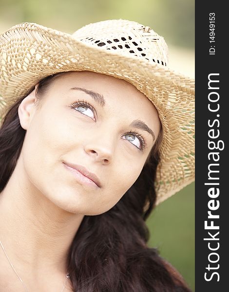 Portrait of smiling attractive young woman wearing straw hat. Portrait of smiling attractive young woman wearing straw hat