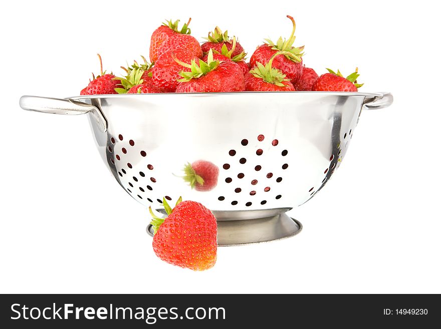 Strawberries in a colander isolated on the white