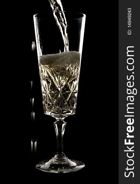 Champagne being poured in crystal glass in studio
