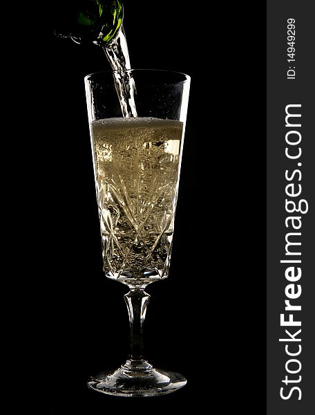 Champagne being poured in crystal glass in studio