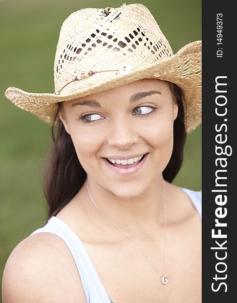 Portrait of smiling attractive young woman wearing straw hat. Portrait of smiling attractive young woman wearing straw hat