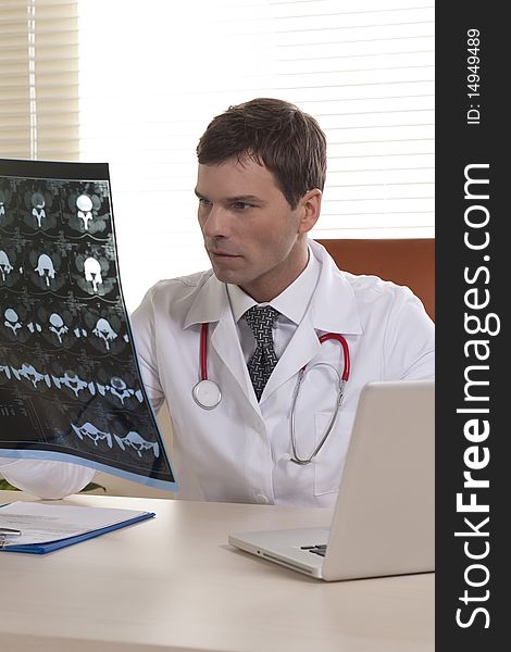 Male Doctor Examining CAT scan in his studio