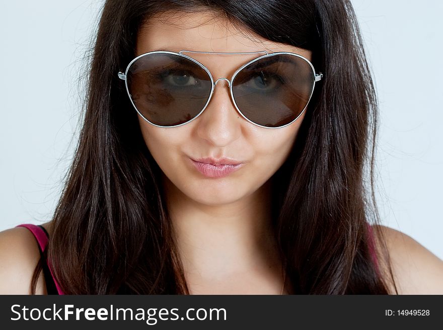 Fashion portrait of young pretty woman with glasses