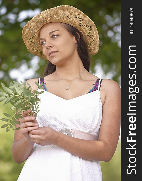 Portrait of thoughtful attractive young woman wearing straw hat. Portrait of thoughtful attractive young woman wearing straw hat