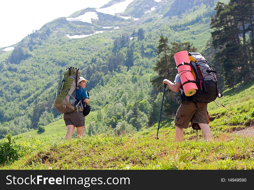 Hiker family in Caucasus mountains