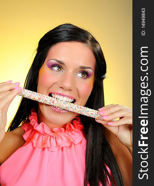 Beautiful happy girl with a sweet lollipop