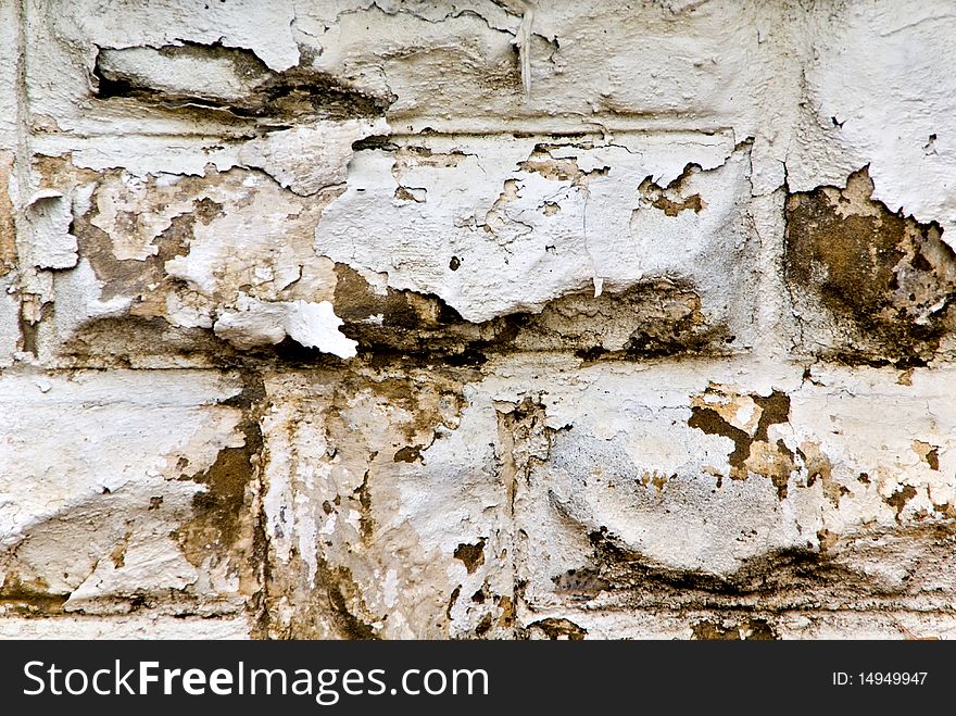 Peeling white paint on a cement wall looking grungy and old. Peeling white paint on a cement wall looking grungy and old.