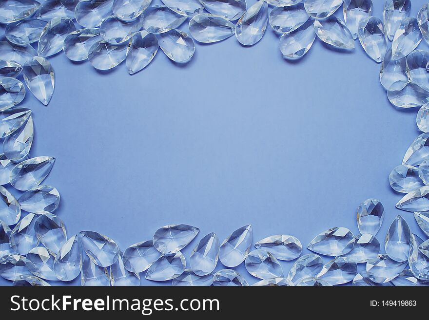 Background template with synthetic decorative crystals and copy blank space on blue background. Background template with synthetic decorative crystals and copy blank space on blue background