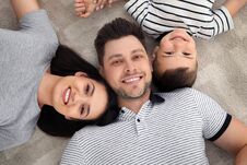 Happy Parents And Their Son Lying Together On Floor. Family Time Royalty Free Stock Image