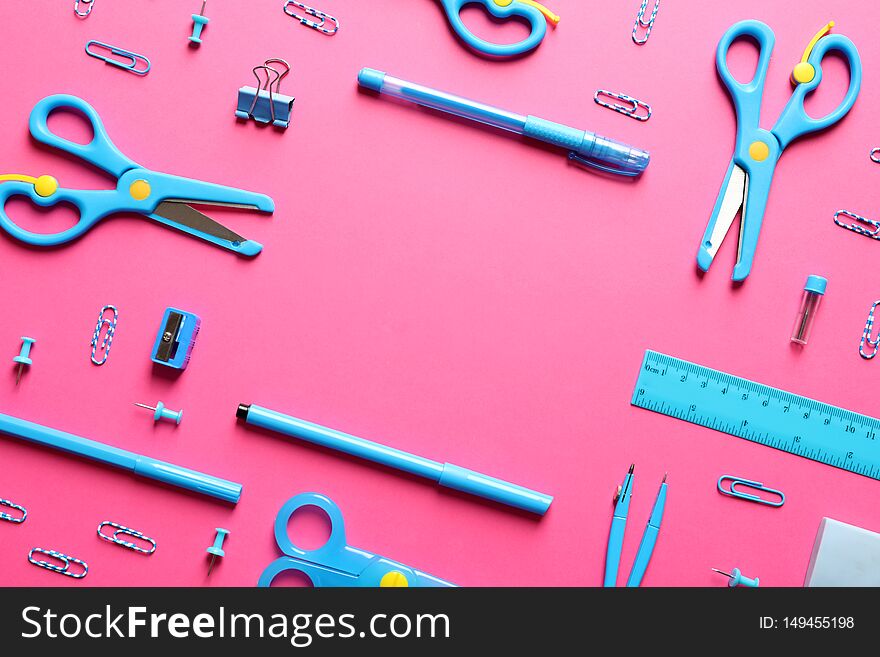 Flat lay composition with scissors and school supplies on color background. Space for text