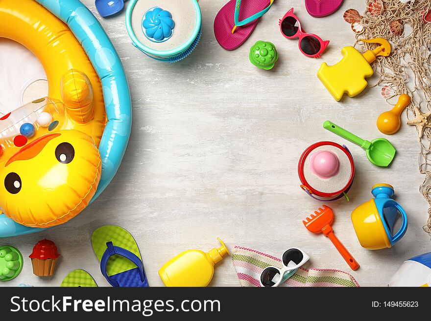 Flat lay composition with beach toys on light background