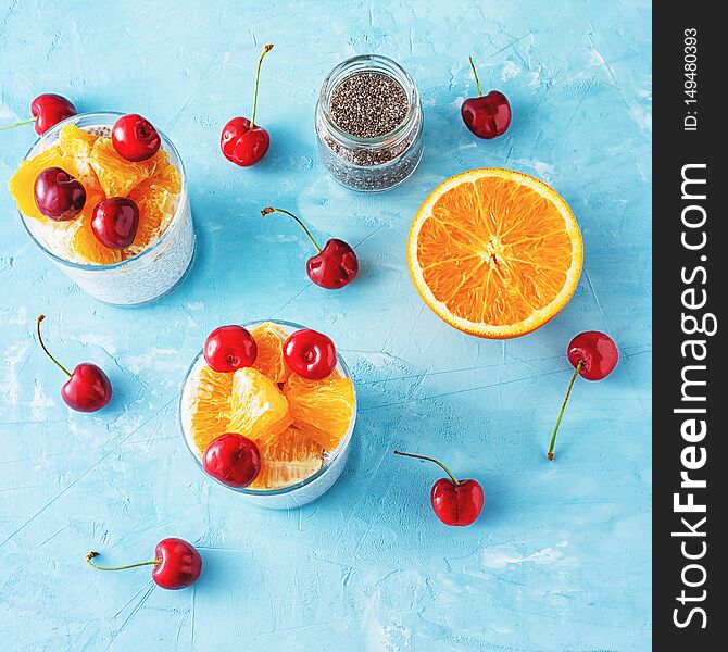 Cottage Cheese Chia Seeds Nutritious Breakfast. Yogurt Dessert with Fruit Adding Flatlay. Mousse Serving, Orange, Cherry and Glass Jar with Superfood on Neutral Background. Healthy Eating