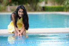 Girl Sitting At Pool Stock Photo