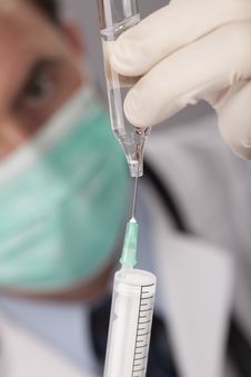 Doctor With Medical Syringe In Hands Stock Photo
