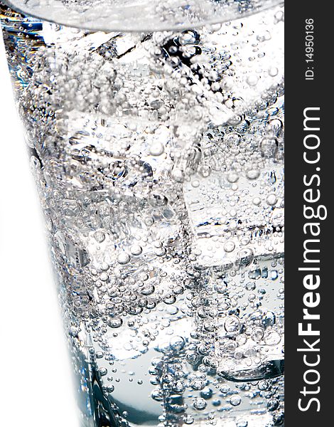 Macro image of ice cubes and water bubbles in a glass