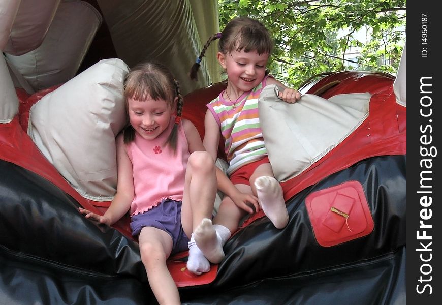 The photo shows children jumping on a trampoline