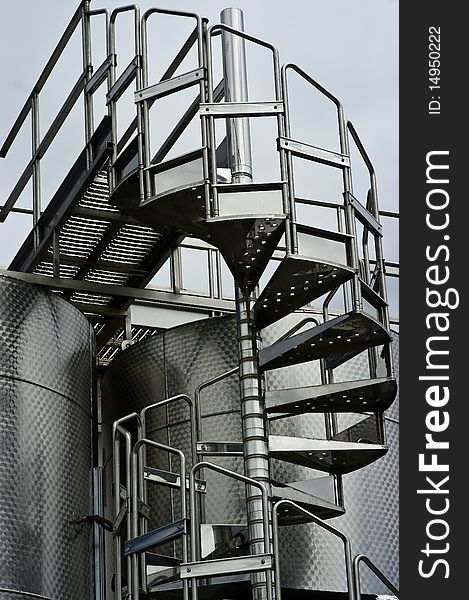 Chrome Circular Stairway & Wine Fermentation Tanks