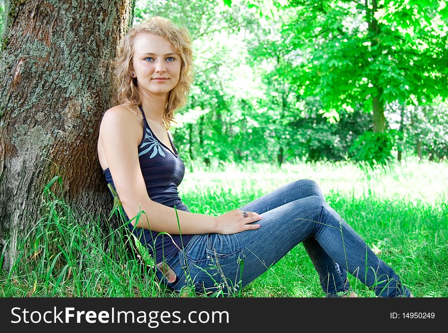 Portrait of young beautiful girl based on the park tree. Portrait of young beautiful girl based on the park tree.