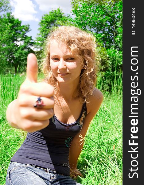 Young beautiful girl shows a thumbs-up gesture. Young beautiful girl shows a thumbs-up gesture.
