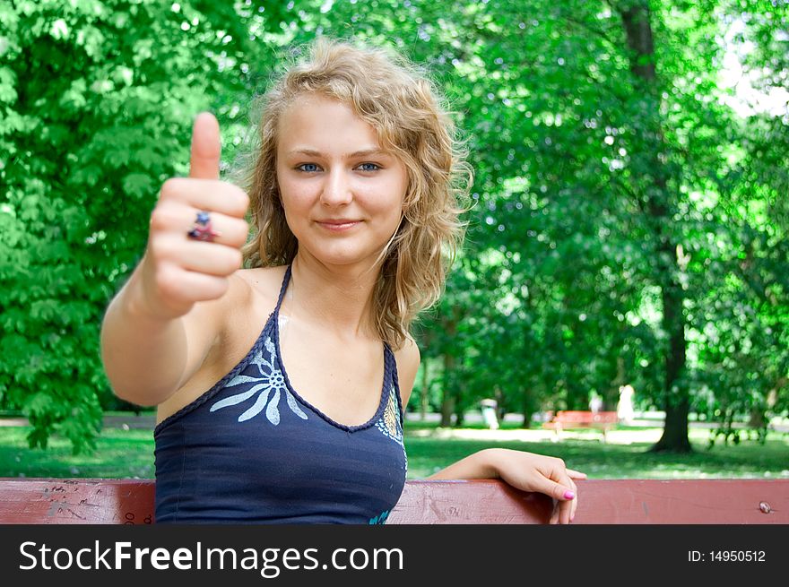 Young beautiful girl shows a thumbs-up gesture. Young beautiful girl shows a thumbs-up gesture.