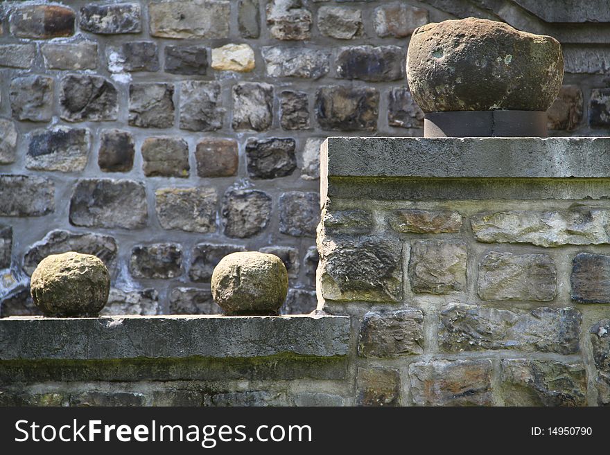 Stone balls used as decorative elements on a castle wall