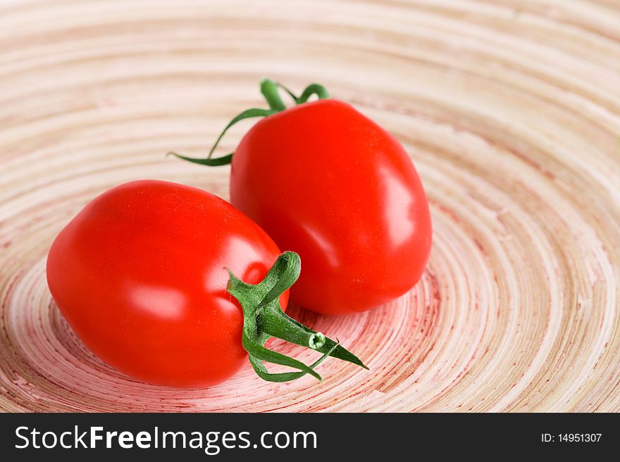 Two tomatoes closeup on wooden table