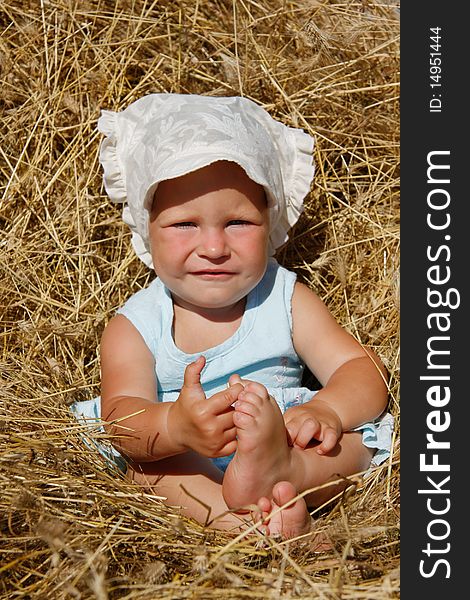 Cute toddler girl in hay