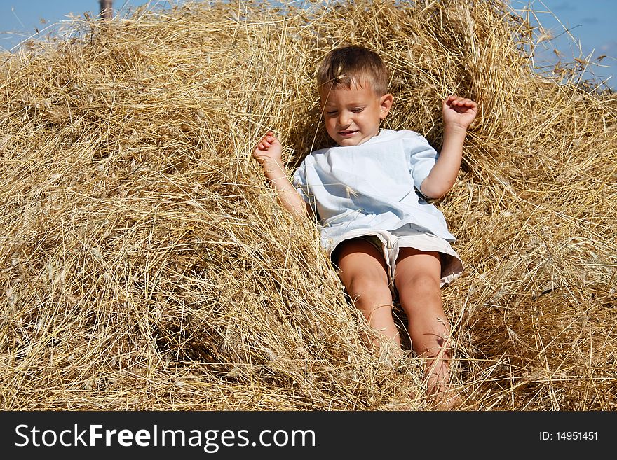 Boy playing in hay