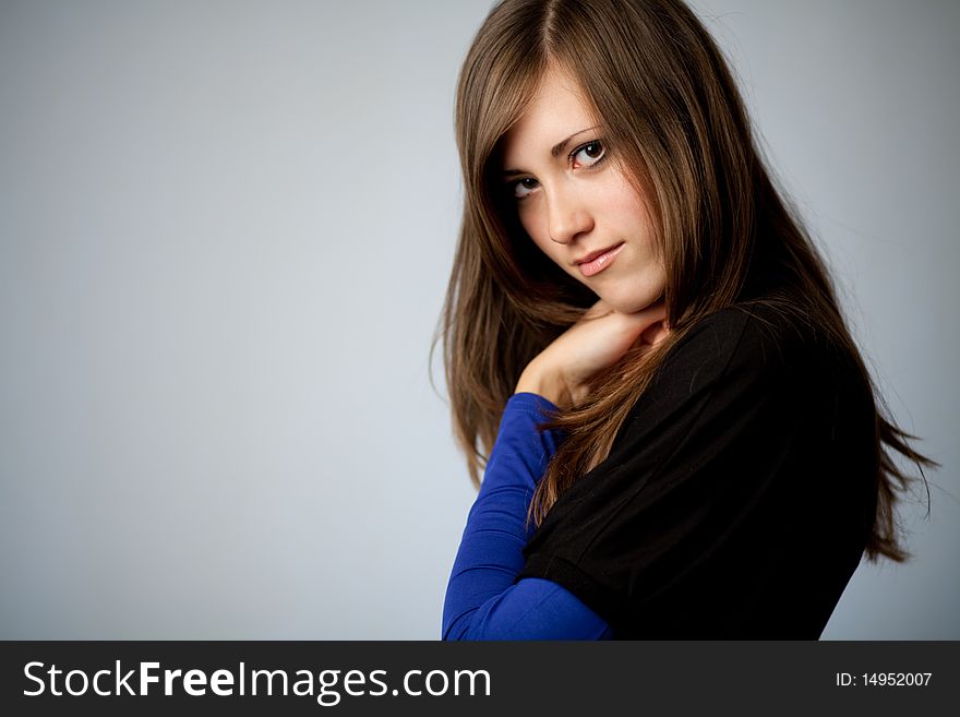 Beautiful young woman on gray background