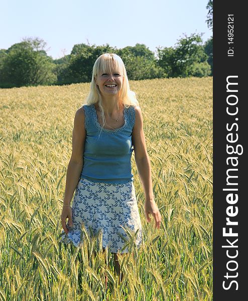 Blond woman in field of wheat