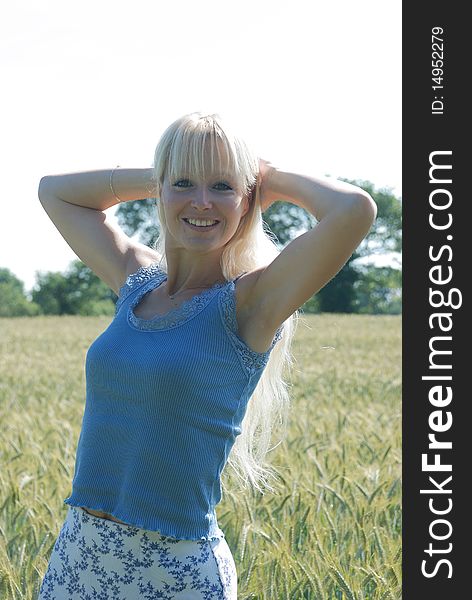 Blond woman in field of wheat